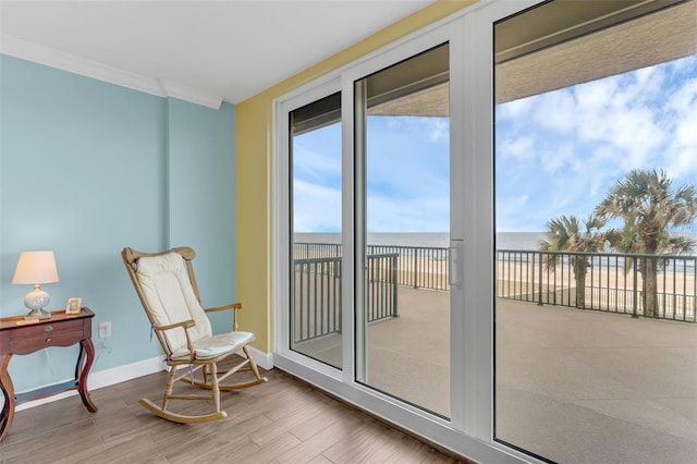 4631 S Atlantic Ave Unit 8102, Port Orange, FL 32127 - sitting room featuring wood finished floors, a water view, and ornamental molding