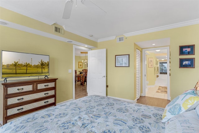 4631 S Atlantic Ave Unit 8102, Port Orange, FL 32127 - bedroom featuring ornamental molding, ensuite bathroom, a ceiling fan, and wood finished floors