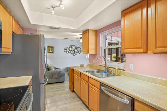 109 Woodfield Ct, Sanford, FL 32773 - kitchen with dishwasher, a raised ceiling, light countertops, light wood-style flooring, and a ceiling fan