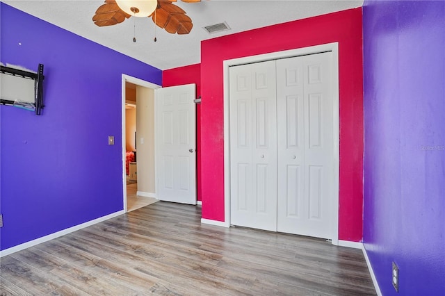 109 Woodfield Ct, Sanford, FL 32773 - unfurnished bedroom with wood finished floors, a closet, and ceiling fan