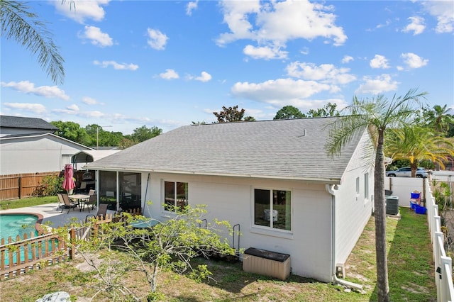 109 Woodfield Ct, Sanford, FL 32773 - back of property featuring a shingled roof, a fenced backyard, and a patio area