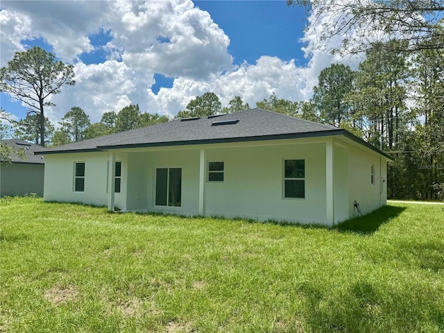 142 W Diego Pl, Citrus Springs, FL 34434 - back of property with a yard, stucco siding, and roof with shingles