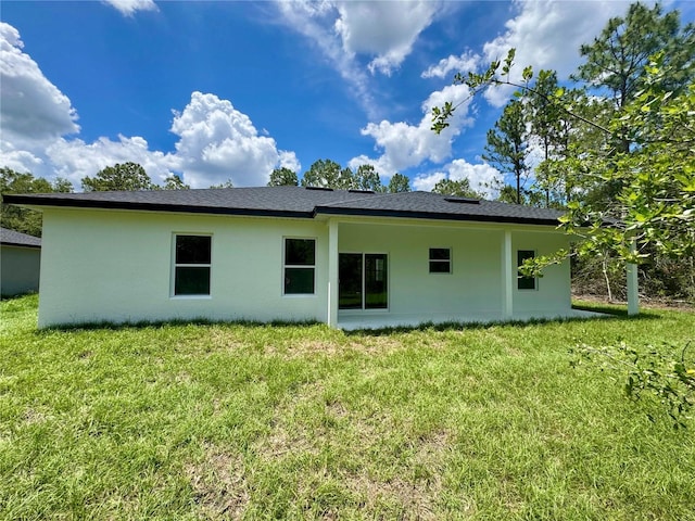 142 W Diego Pl, Citrus Springs, FL 34434 - back of house with stucco siding and a yard