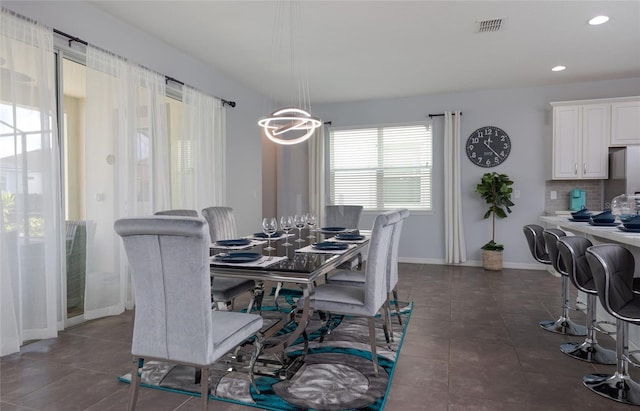 1811 Caribbean View Ter, Kissimmee, FL 34747 - dining area featuring dark tile patterned floors and recessed lighting