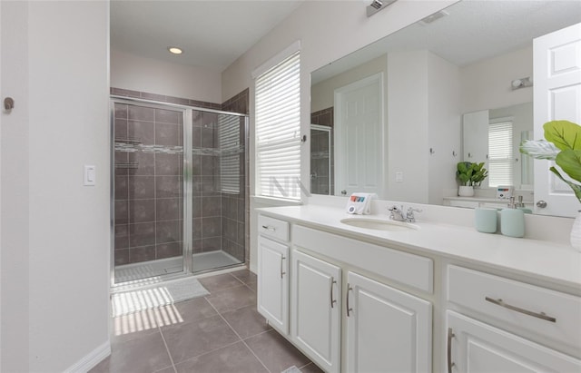 1811 Caribbean View Ter, Kissimmee, FL 34747 - bathroom featuring vanity, a shower stall, healthy amount of natural light, and tile patterned flooring