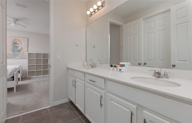 1811 Caribbean View Ter, Kissimmee, FL 34747 - bathroom featuring double vanity, ceiling fan, and tile patterned flooring