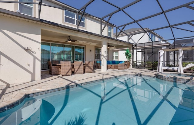 1811 Caribbean View Ter, Kissimmee, FL 34747 - view of pool featuring outdoor lounge area, ceiling fan, a patio, a pool with connected hot tub, and glass enclosure