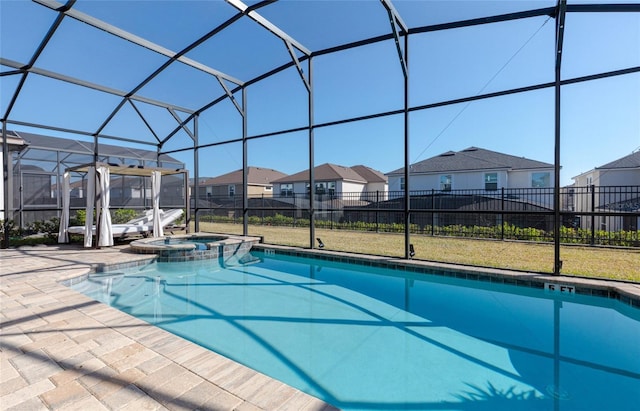 1811 Caribbean View Ter, Kissimmee, FL 34747 - view of swimming pool featuring a residential view, a patio, a pool with connected hot tub, and glass enclosure