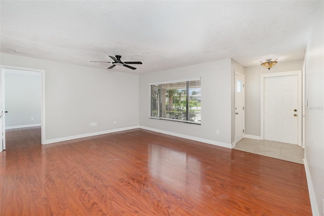 917 Great Bend Rd, Altamonte Springs, FL 32714 - unfurnished living room with wood finished floors, a textured ceiling, and ceiling fan