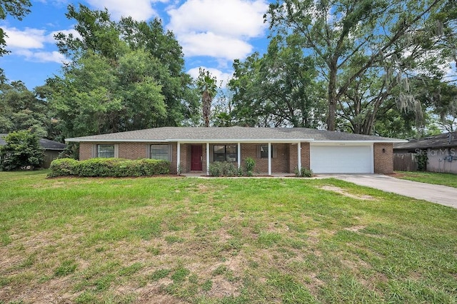 5460 SE 28th St, Ocala, FL 34480 - ranch-style house featuring a garage, brick siding, driveway, and a front lawn