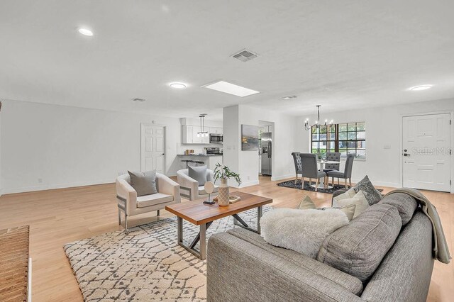 5460 SE 28th St, Ocala, FL 34480 - living area with a chandelier, light wood finished floors, and recessed lighting