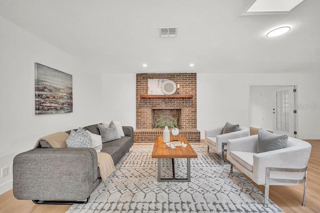5460 SE 28th St, Ocala, FL 34480 - living room featuring wood finished floors, a brick fireplace, and recessed lighting