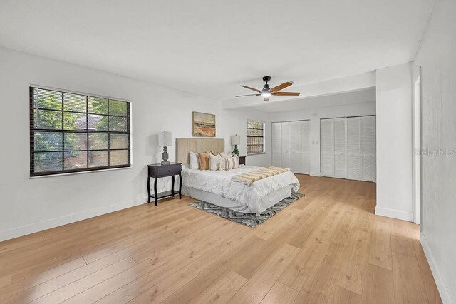 5460 SE 28th St, Ocala, FL 34480 - bedroom featuring wood finished floors, two closets, and a ceiling fan