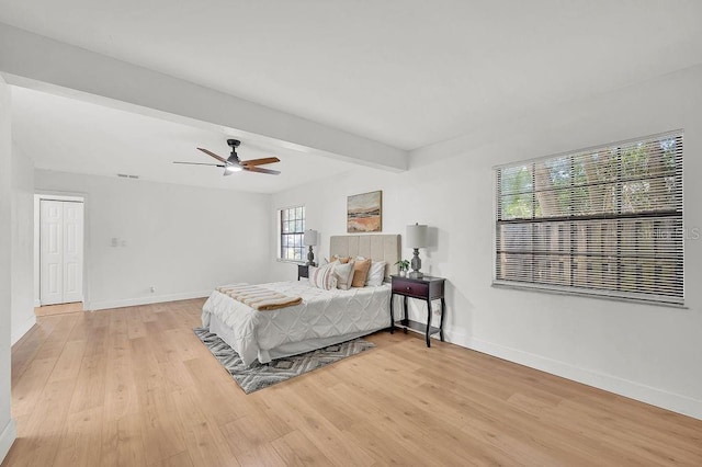 5460 SE 28th St, Ocala, FL 34480 - bedroom with light wood-style flooring, a ceiling fan, and beam ceiling