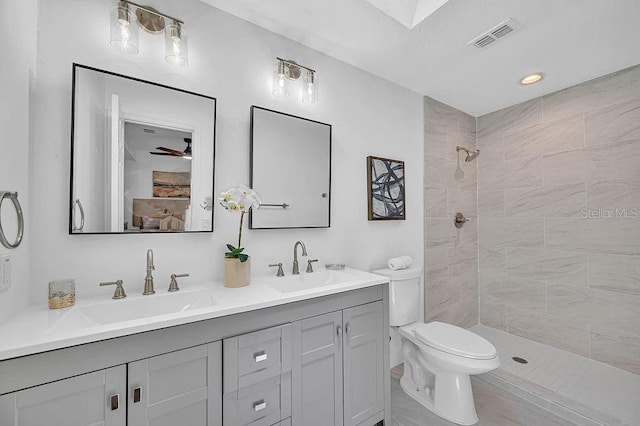 5460 SE 28th St, Ocala, FL 34480 - bathroom with double vanity, a tile shower, and ceiling fan