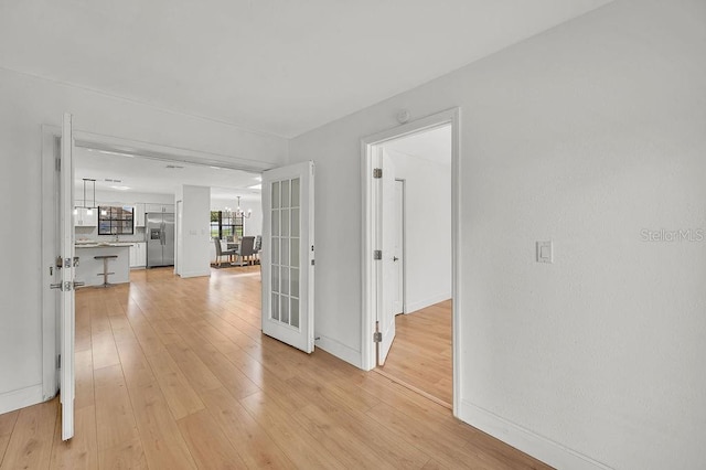 5460 SE 28th St, Ocala, FL 34480 - corridor featuring a chandelier and light wood-type flooring