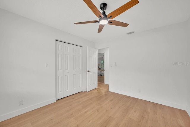 5460 SE 28th St, Ocala, FL 34480 - unfurnished bedroom with light wood-type flooring, a closet, and ceiling fan