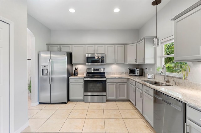 1785 Rushden Dr, Ocoee, FL 34761 - kitchen featuring stainless steel appliances, gray cabinets, recessed lighting, light tile patterned floors, and arched walkways