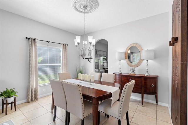 1785 Rushden Dr, Ocoee, FL 34761 - dining space with a chandelier, light tile patterned flooring, and arched walkways