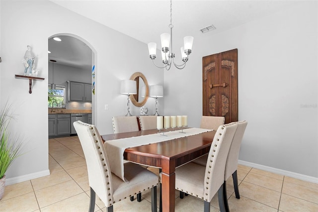 1785 Rushden Dr, Ocoee, FL 34761 - dining area featuring arched walkways, light tile patterned flooring, and a chandelier
