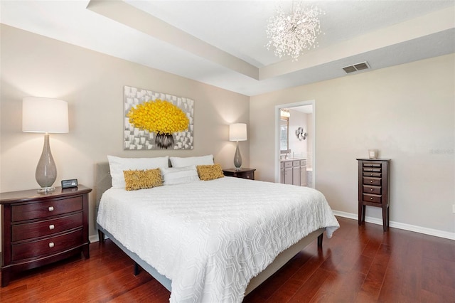 1785 Rushden Dr, Ocoee, FL 34761 - bedroom with wood finished floors, a chandelier, a tray ceiling, and connected bathroom