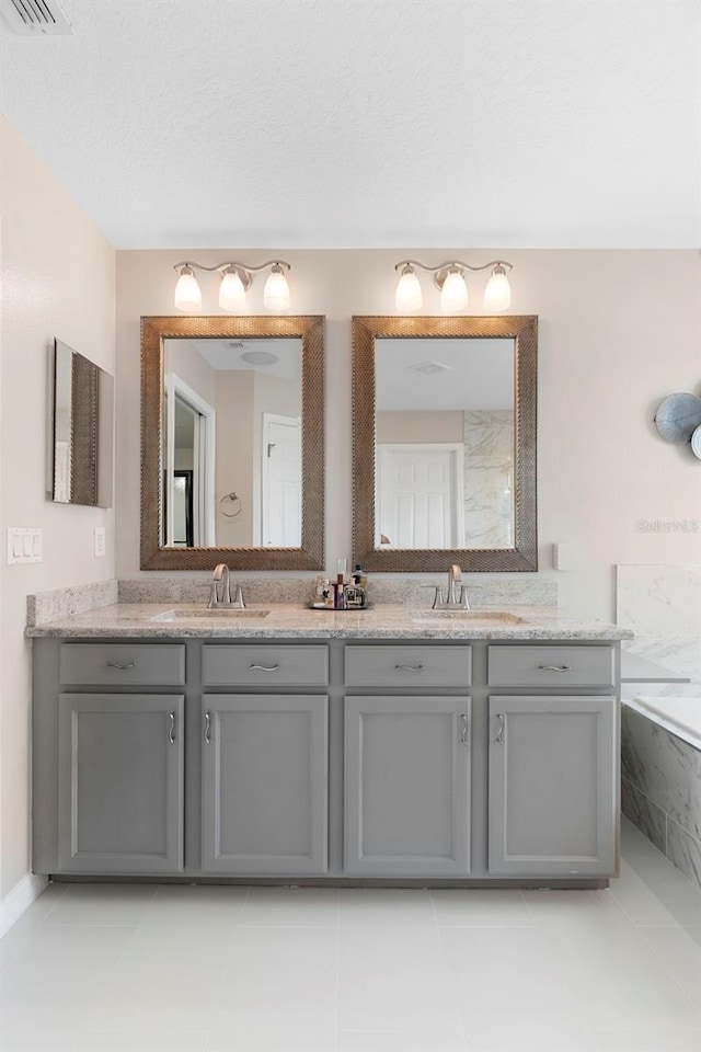 1785 Rushden Dr, Ocoee, FL 34761 - full bath with double vanity, a tub with marble appearance, and tile patterned floors