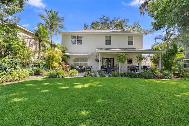 1785 Rushden Dr, Ocoee, FL 34761 - rear view of house featuring stucco siding, a yard, and a patio