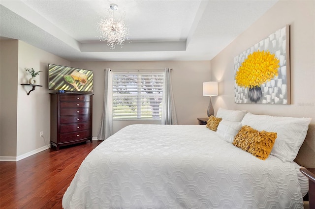 1785 Rushden Dr, Ocoee, FL 34761 - bedroom featuring wood finished floors, a raised ceiling, and a chandelier
