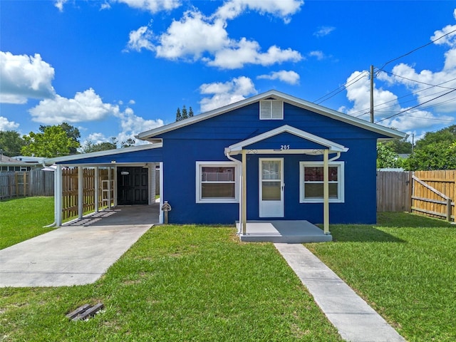 205 9th St, Saint Cloud, FL 34769 - view of front facade featuring a carport, driveway, and stucco siding