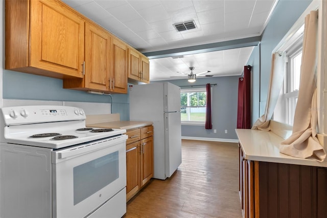 205 9th St, Saint Cloud, FL 34769 - kitchen featuring white appliances, light wood-style floors, light countertops, ceiling fan, and brown cabinets