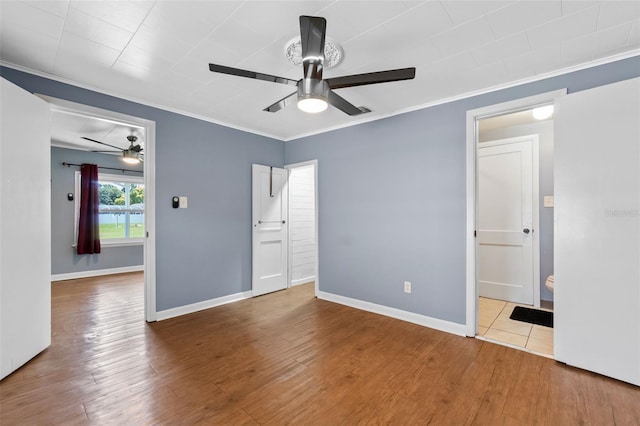 205 9th St, Saint Cloud, FL 34769 - unfurnished bedroom featuring ornamental molding, wood finished floors, and a ceiling fan
