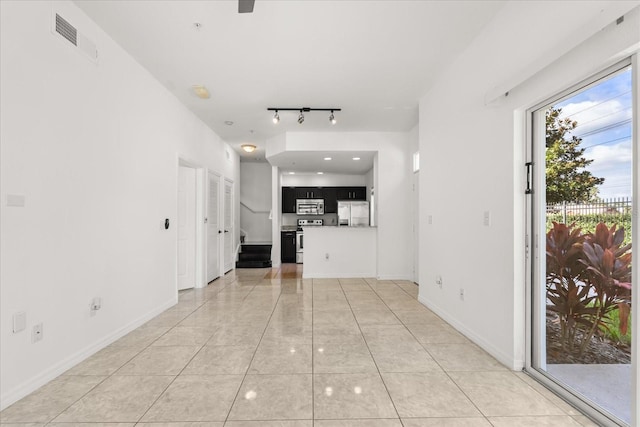 2280 San Vital Dr Unit 101, Kissimmee, FL 34741 - unfurnished living room with light tile patterned floors and rail lighting
