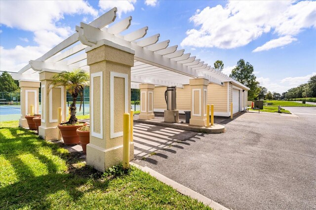 2280 San Vital Dr Unit 101, Kissimmee, FL 34741 - view of property exterior featuring a pergola, a patio, and stucco siding