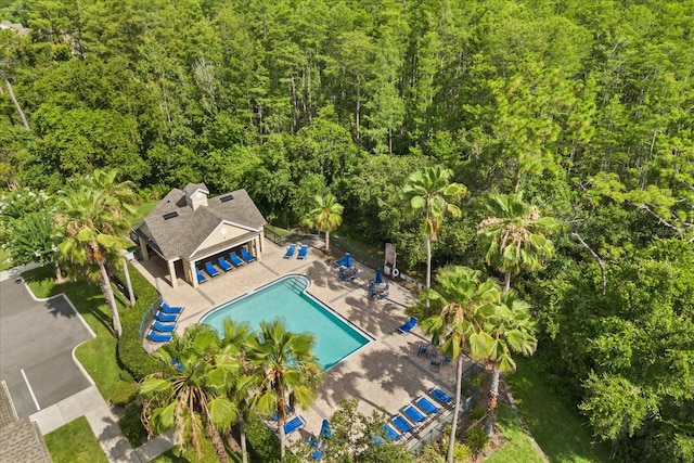 2280 San Vital Dr Unit 101, Kissimmee, FL 34741 - drone / aerial view of a pool area and a heavily wooded area