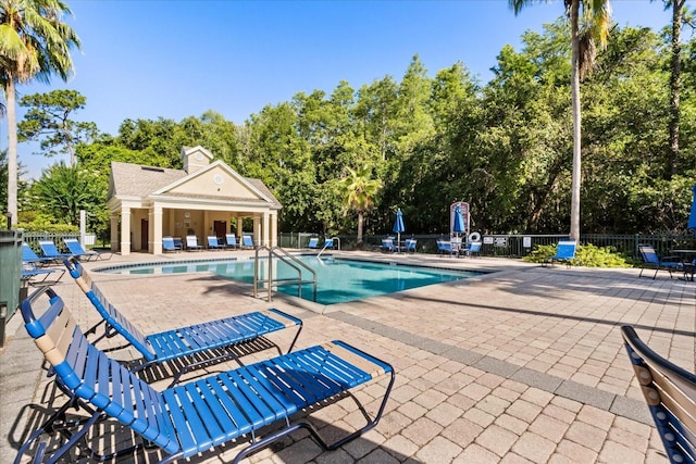 2280 San Vital Dr Unit 101, Kissimmee, FL 34741 - community pool featuring a patio area and view of scattered trees