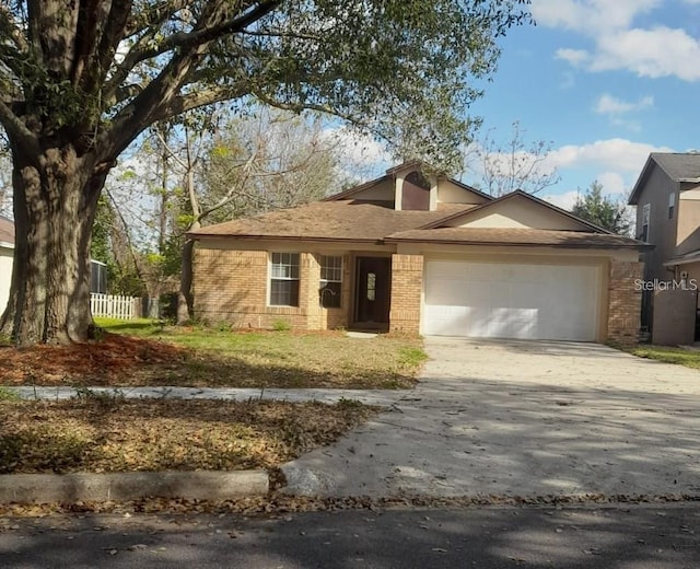 3013 Barrymore Ct, Orlando, FL 32835 - ranch-style home with brick siding, concrete driveway, and an attached garage