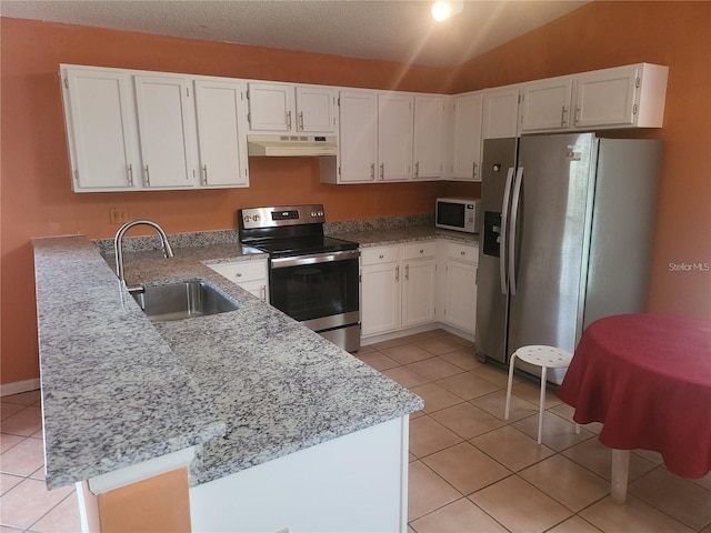 3013 Barrymore Ct, Orlando, FL 32835 - kitchen with under cabinet range hood, stainless steel appliances, a peninsula, light tile patterned floors, and light stone counters