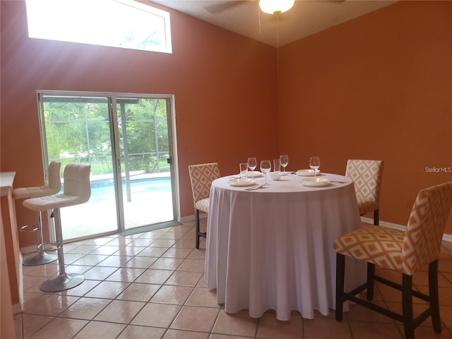 3013 Barrymore Ct, Orlando, FL 32835 - dining room with ceiling fan, light tile patterned floors, and high vaulted ceiling