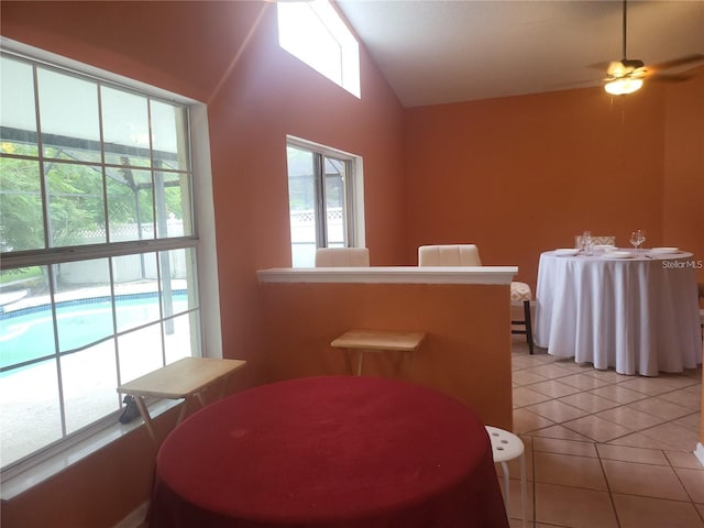 3013 Barrymore Ct, Orlando, FL 32835 - dining room with light tile patterned floors, vaulted ceiling, and ceiling fan