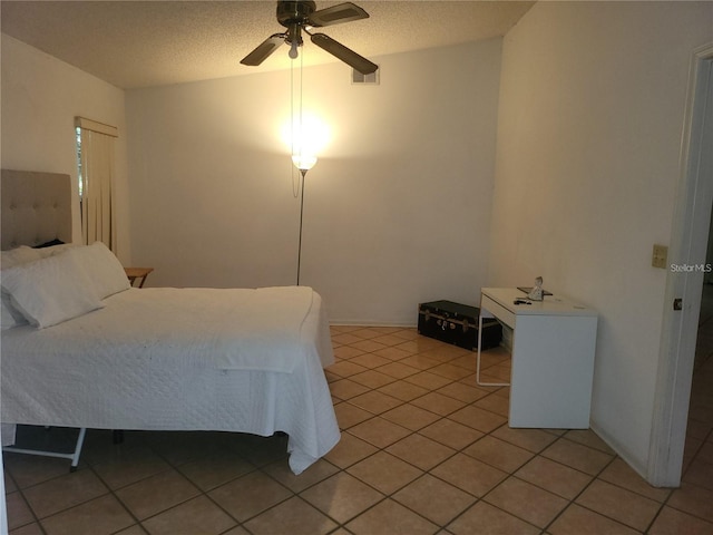 3013 Barrymore Ct, Orlando, FL 32835 - bedroom with light tile patterned floors, ceiling fan, and a textured ceiling