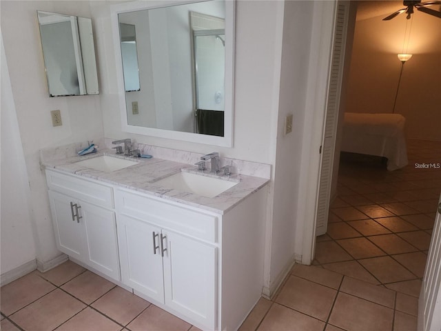 3013 Barrymore Ct, Orlando, FL 32835 - bathroom with double vanity, tile patterned floors, a closet, and a ceiling fan