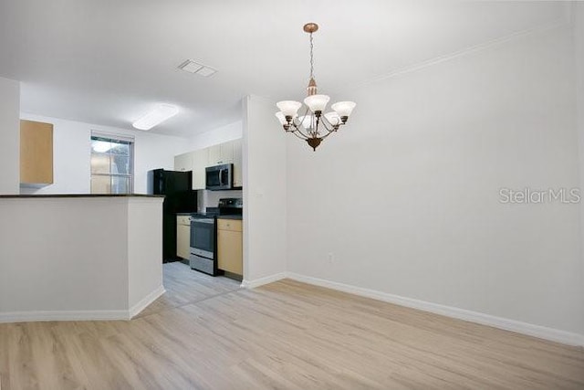 710 Siena Palm Dr Unit 104, Celebration, FL 34747 - kitchen with electric range, dark countertops, light wood finished floors, a chandelier, and freestanding refrigerator