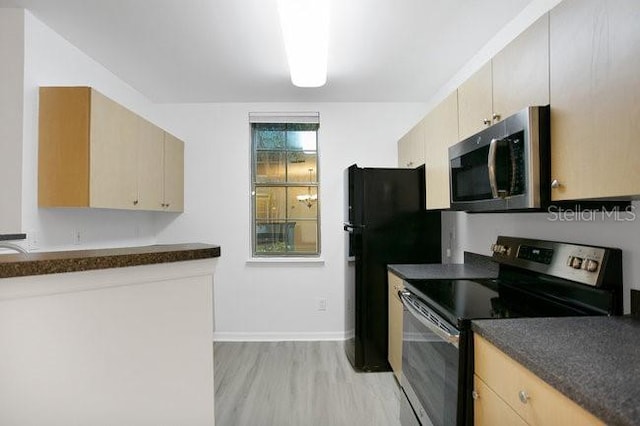 710 Siena Palm Dr Unit 104, Celebration, FL 34747 - kitchen featuring stainless steel appliances, dark countertops, and light wood-style flooring