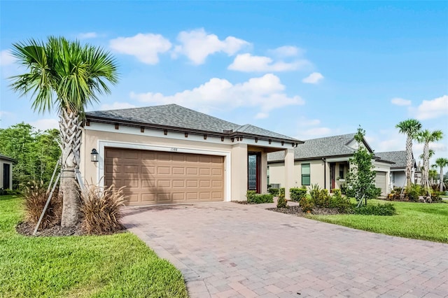 1388 Lombardi Ct, Kissimmee, FL 34759 - view of front of property with stucco siding, driveway, an attached garage, a front lawn, and a shingled roof