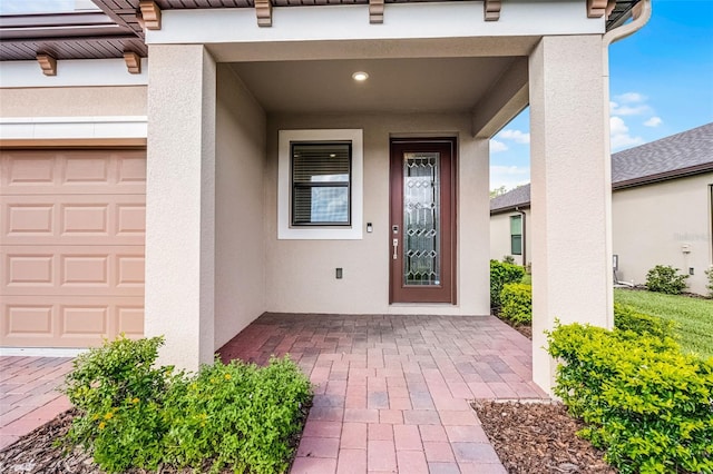 1388 Lombardi Ct, Kissimmee, FL 34759 - view of exterior entry with stucco siding and a garage
