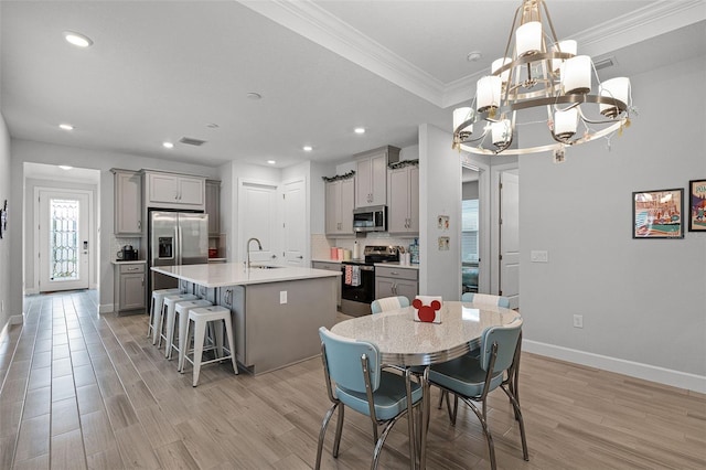 1388 Lombardi Ct, Kissimmee, FL 34759 - dining room featuring a chandelier, crown molding, light wood-type flooring, and recessed lighting