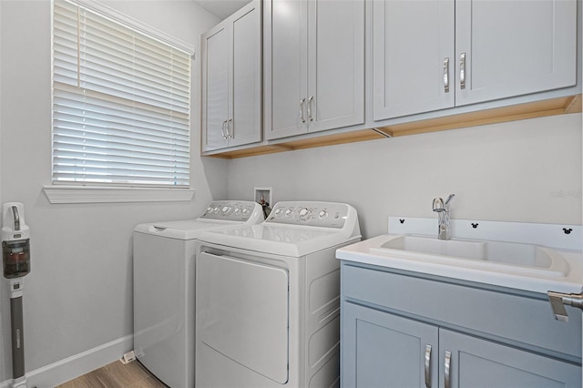 1388 Lombardi Ct, Kissimmee, FL 34759 - laundry room with independent washer and dryer, cabinet space, and light wood-style floors