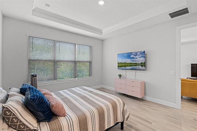 1388 Lombardi Ct, Kissimmee, FL 34759 - bedroom featuring ornamental molding, multiple windows, light wood-type flooring, and a tray ceiling