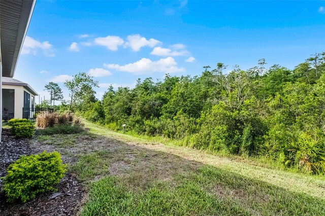 1388 Lombardi Ct, Kissimmee, FL 34759 - view of yard featuring a wooded view