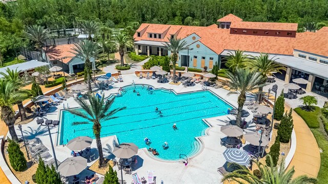 1388 Lombardi Ct, Kissimmee, FL 34759 - community pool with a patio area and a view of trees